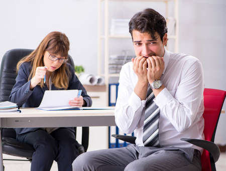 Man and woman discussing in officeの写真素材