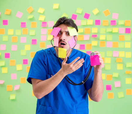 Young doctor with many reminders and urgent work
