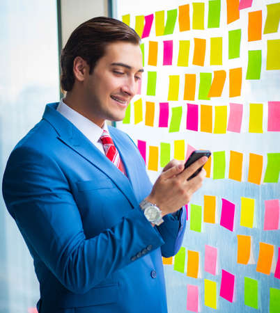 Young handsome employee with many conflicting prioritiesの写真素材