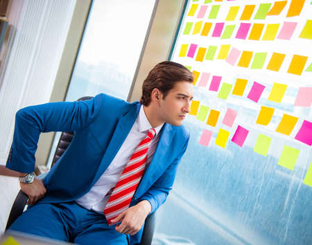 Young handsome employee with many conflicting prioritiesの写真素材