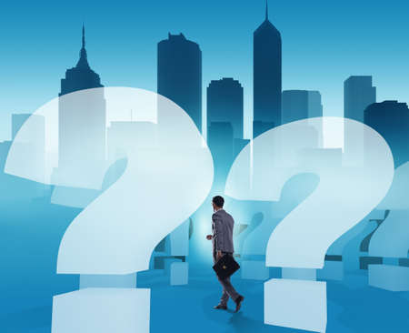 Businessman in uncertainty concept with question marksの写真素材
