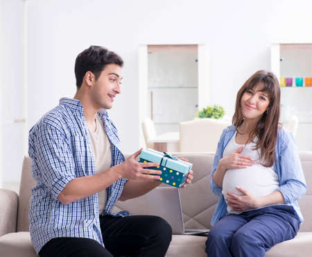 Happy family celebrating pregnancy at homeの写真素材