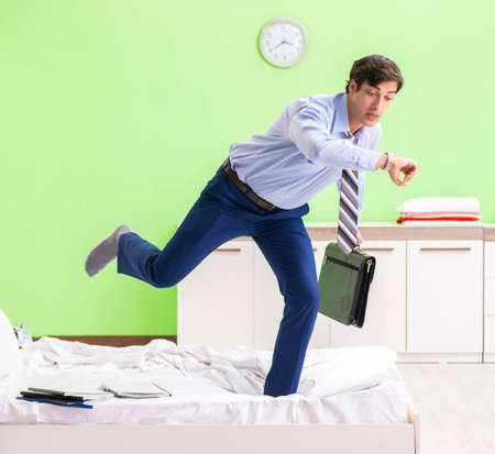 Young businessman employee late for officeの写真素材