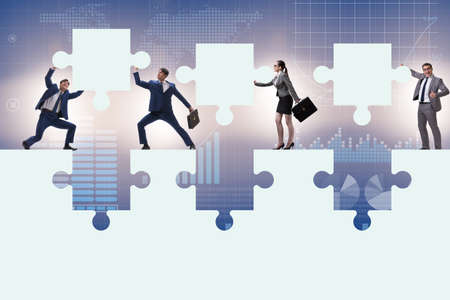 Businessman in the teamwork concept with jigsaw puzzleの写真素材