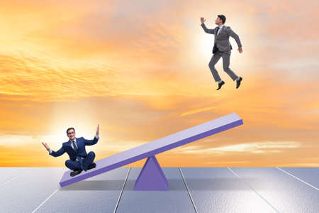 Competition concept with businessman and seesawの写真素材