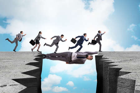 Businessman acting as a bridge in support conceptの写真素材