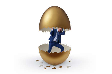 Businessman breaking out of the golden eggの写真素材