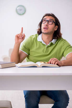 Young male student preparing for exams at homeの写真素材