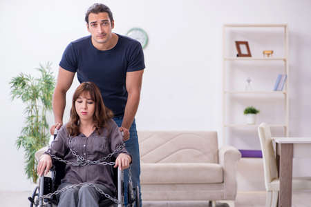 Disabled wife and young husband at homeの写真素材