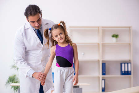 Small girl visiting young male doctorの写真素材