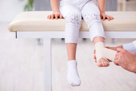 Small girl visiting young male doctorの写真素材