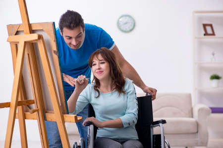 Disabled wife and young husband at homeの写真素材