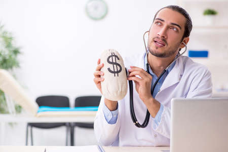 Young handsome male doctor working in the clinicの写真素材