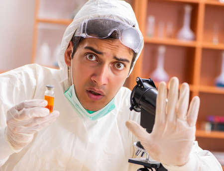 Young biochemist wearing protective suit working in the labの写真素材