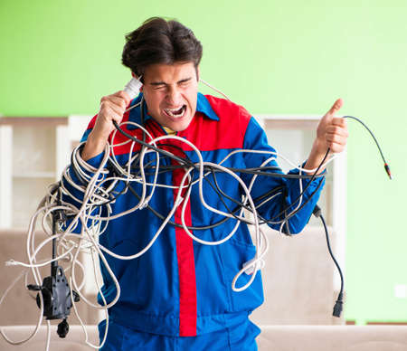 Electrician contractor with tangled cablesの写真素材
