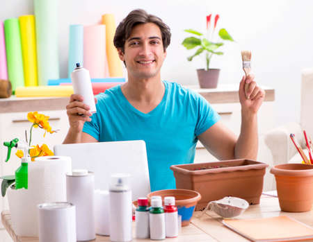 Young man decorating pottery in classの写真素材