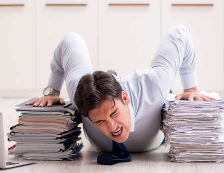 Extremely busy employee working in the officeの写真素材