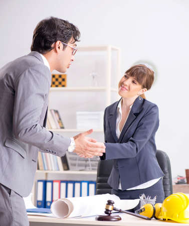Man and woman discussing construction projectの写真素材