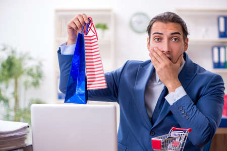 Young male businessman in ecommerce conceptの写真素材