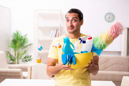Young male contractor doing housework at homeの写真素材