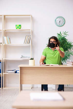 Young man student studying at home in self-isolation conceptの写真素材