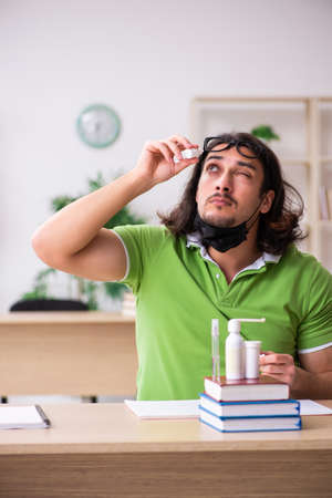 Young man student studying at home in self-isolation conceptの写真素材