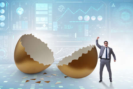 Businessman breaking out of golden egg