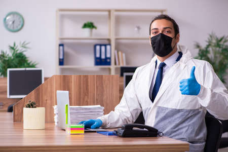 Young male employee in self-isolation conceptの写真素材