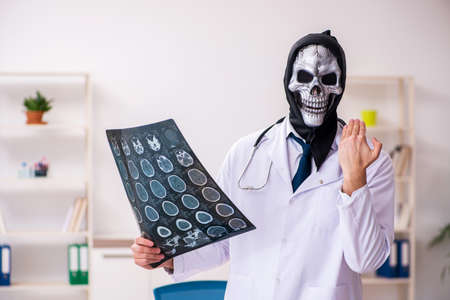 Male devil doctor radiologist working in the clinic