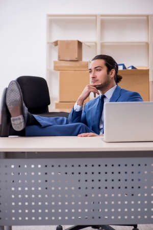 Young male employee in relocation conceptの写真素材