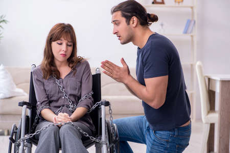 Disabled wife and young husband at homeの写真素材