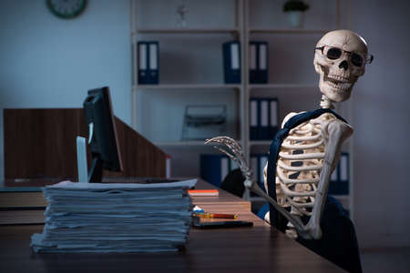 Young employee working in the office night time