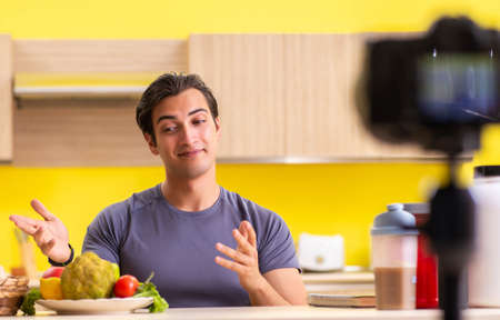 Young man blogging about food supplementsの写真素材