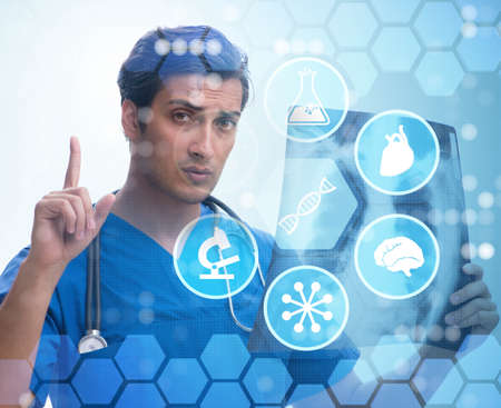 Young doctor looking at x-ray image in mhealth concept