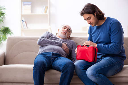 Grandfather and grandson in first aid concept