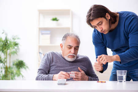 Grandfather and grandson in first aid conceptの写真素材