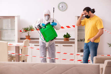 Sanitizer and young man indoors in disinfection conceptの写真素材