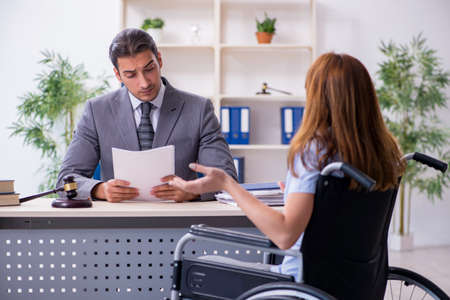 Young injured woman and male lawyer in the courtroomの写真素材