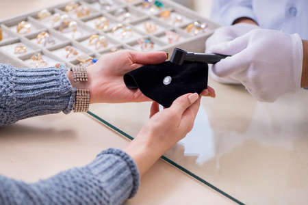 Male jeweler and female client at storeの写真素材