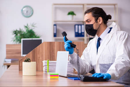 Young male employee in self-isolation conceptの写真素材