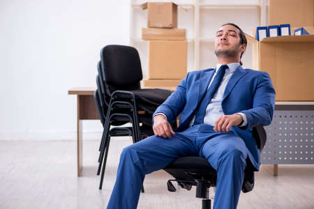 Young male employee in relocation conceptの写真素材