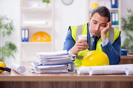 Young male architect working in the office