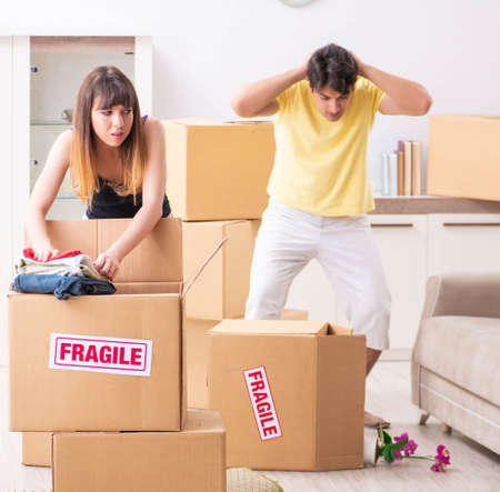 Young couple moving to new flat with fragile things