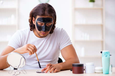 Young male cosmetician recording video for his blogの写真素材