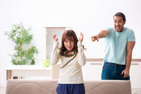 Young couple and snake in the flatの写真素材