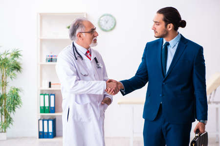 Male doctor and businessman discussing medical projectの写真素材