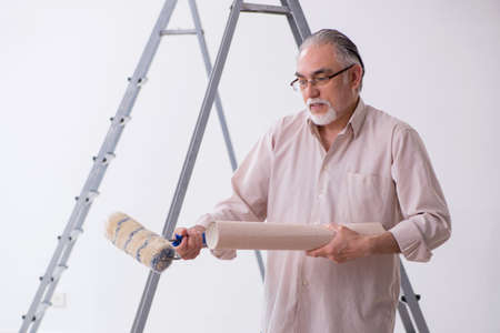 Old husband contractor in home renovation conceptの写真素材