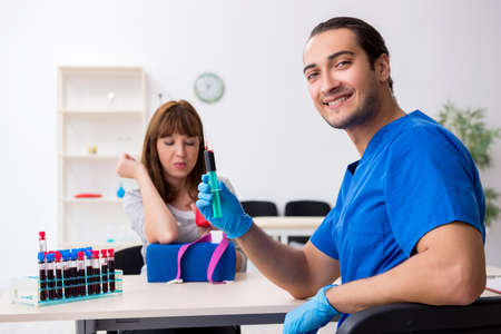 Young woman in blood transfusion conceptの写真素材