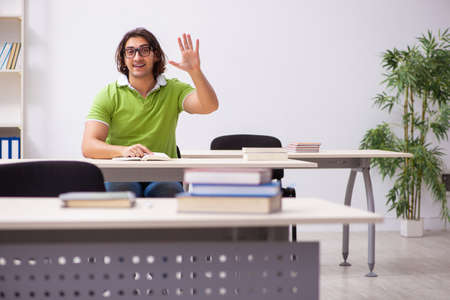 Young male student in the classroomの写真素材