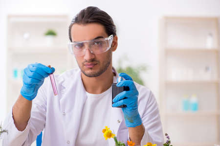 Young male chemist in perfume synthesis conceptの写真素材